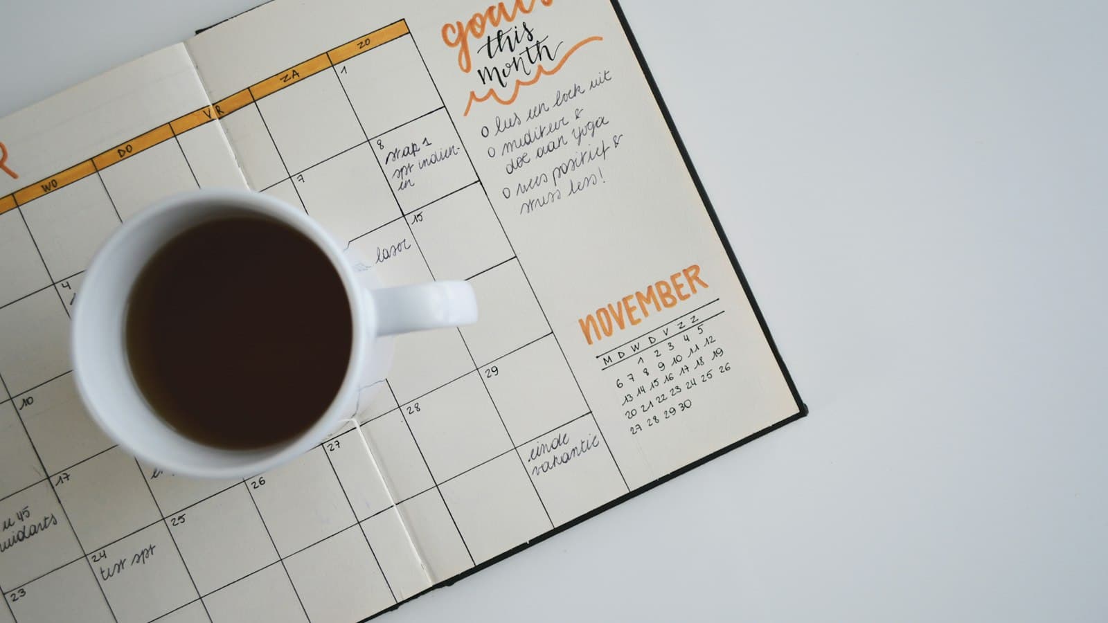 Desk calendar beside a notebook and pen