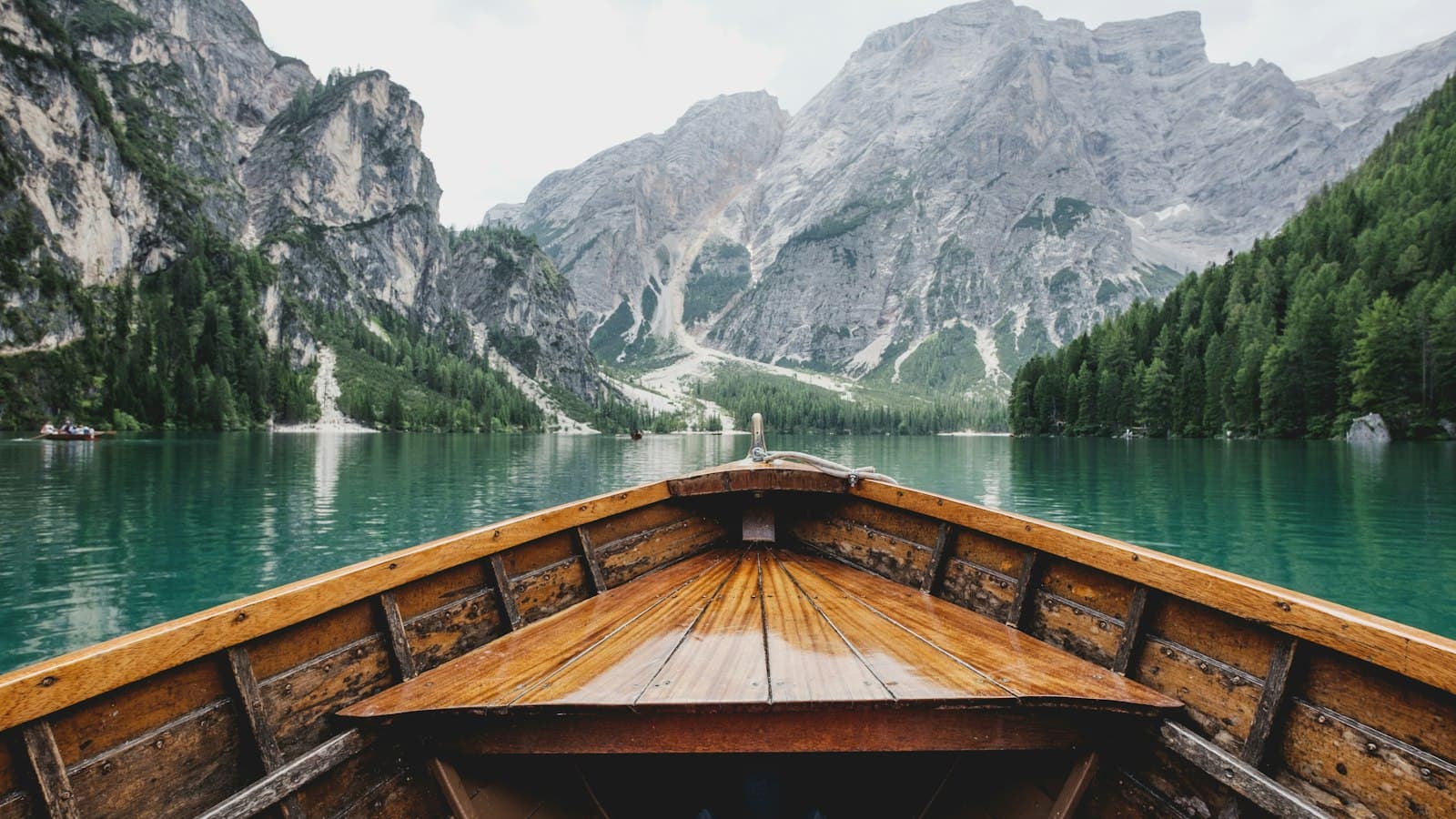 Small boat on a mountain lake at dusk