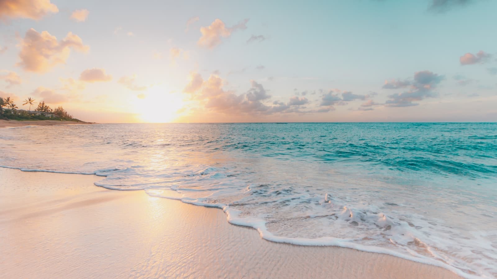 Tropical beach with turquoise water and a few umbrellas
